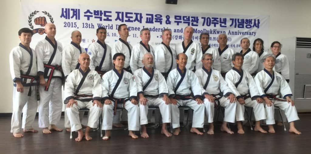 Representatives of the World Moo Duk Kwan Symposium sitting with the World Moo Duk Kwan Leadership.